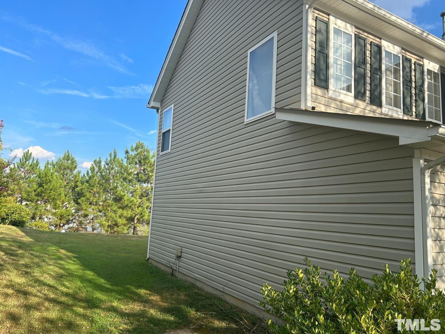 408 Pebblestone Drive Durham, NC 27703 - Photo 2 of 27 a yellow house with tree in front of it
