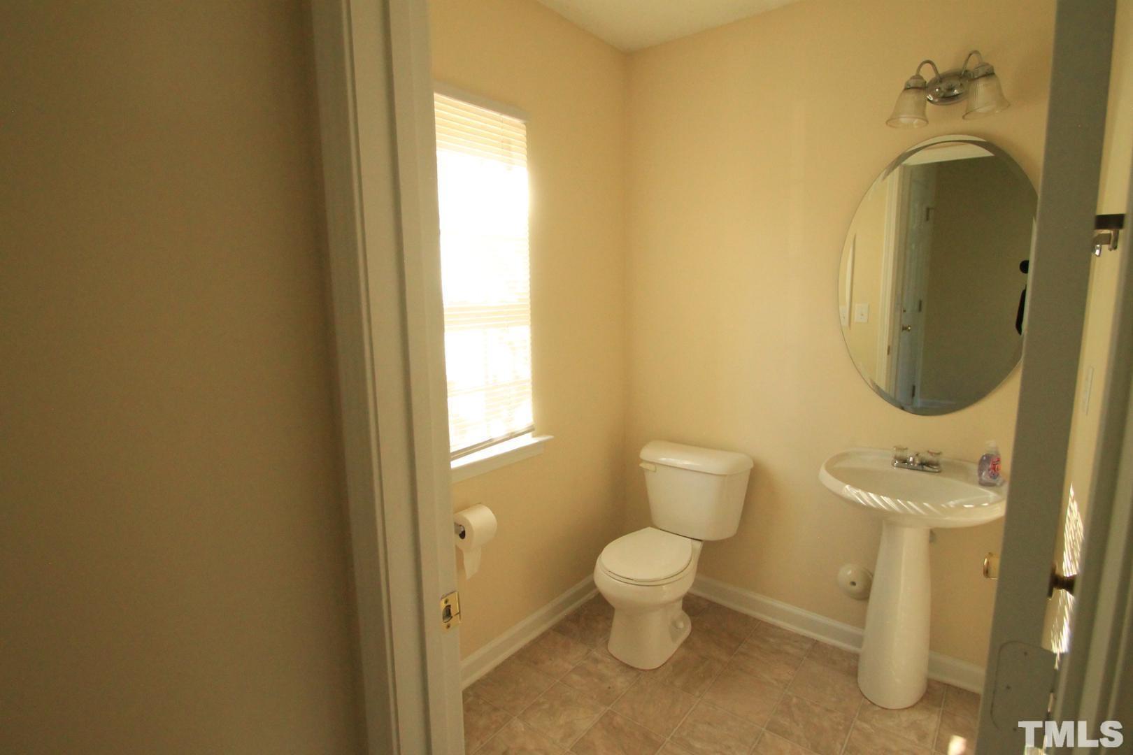 408 Pebblestone Drive Durham, NC 27703 - Photo 6 of 27 a bathroom with a toilet sink and a mirror