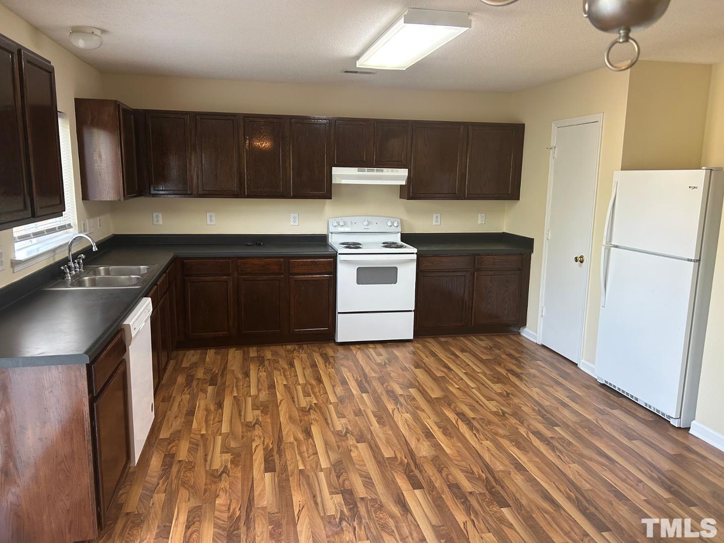 408 Pebblestone Drive Durham, NC 27703 - Photo 7 of 27 a kitchen with a stove sink and a refrigerator