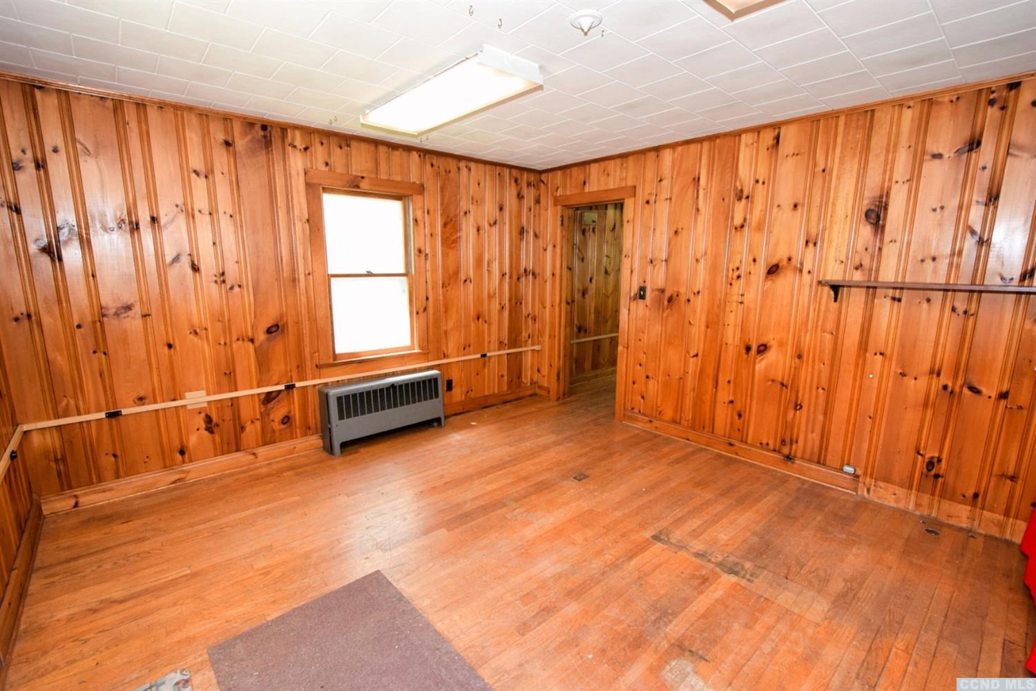 597 Main Street Cairo, NY 12413 - Photo 15 of 23 a room with a door and wooden walls
