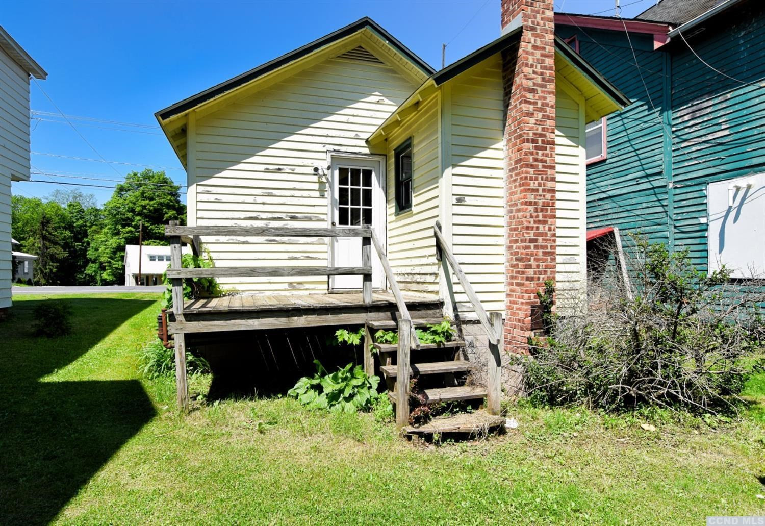 597 Main Street Cairo, NY 12413 - Photo 22 of 23 a view of a chair and table in backyard of the house