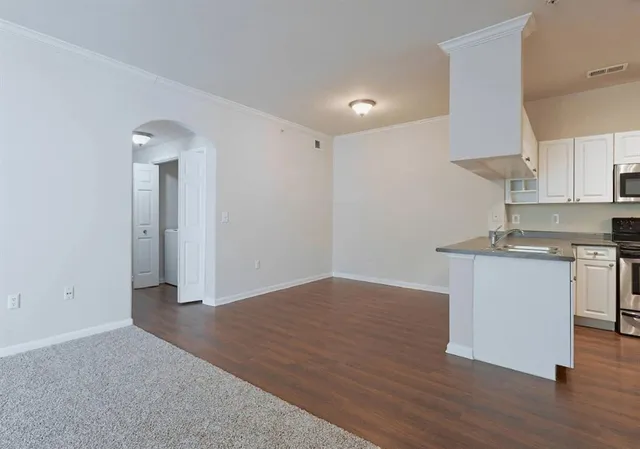 a view of kitchen with granite countertop cabinets and wooden floor