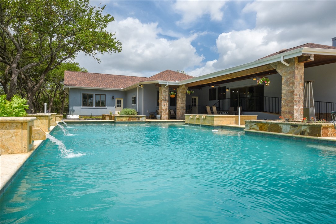 a view of a house with a swimming pool and porch
