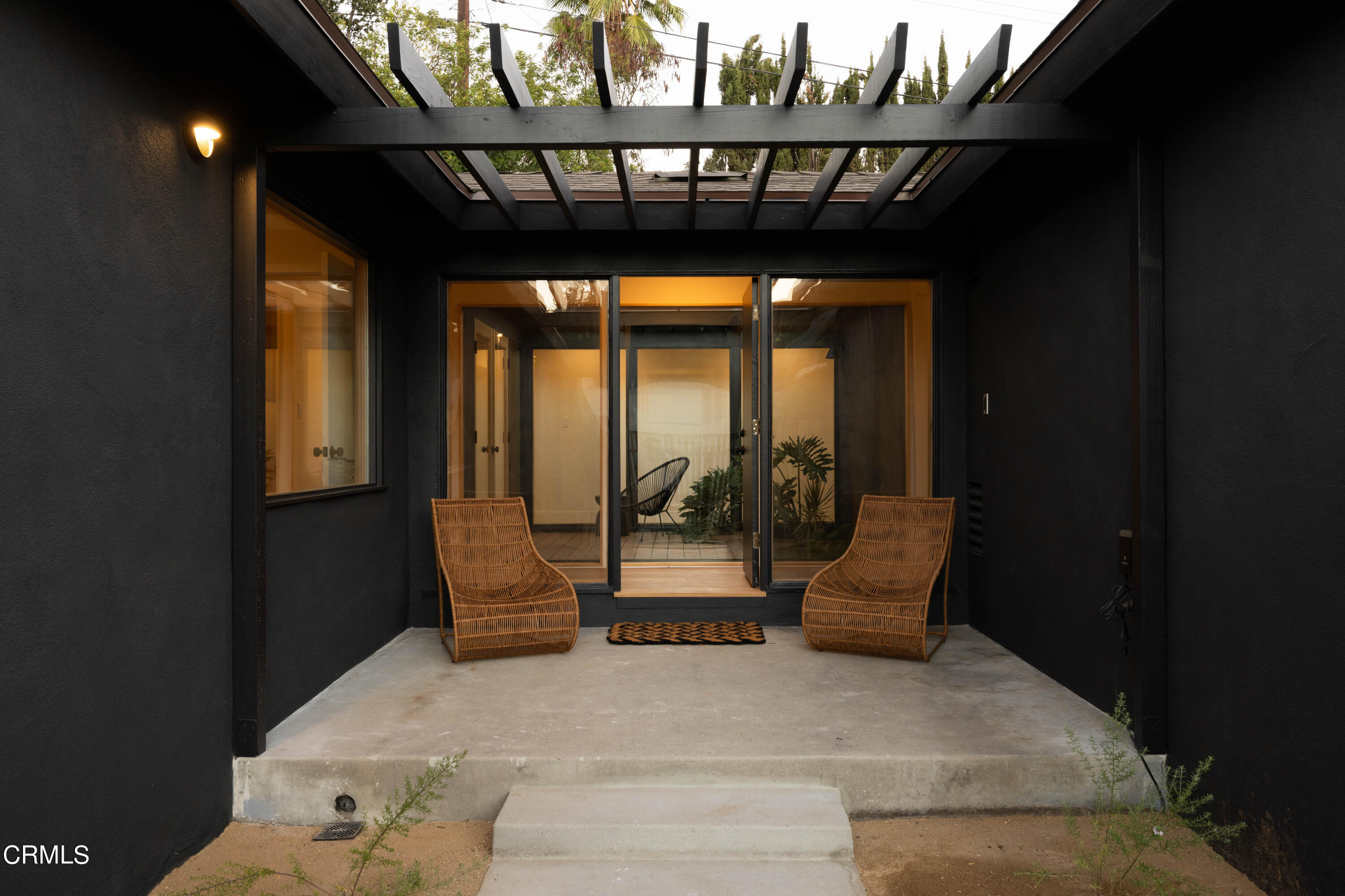a view of porch with a table and chairs