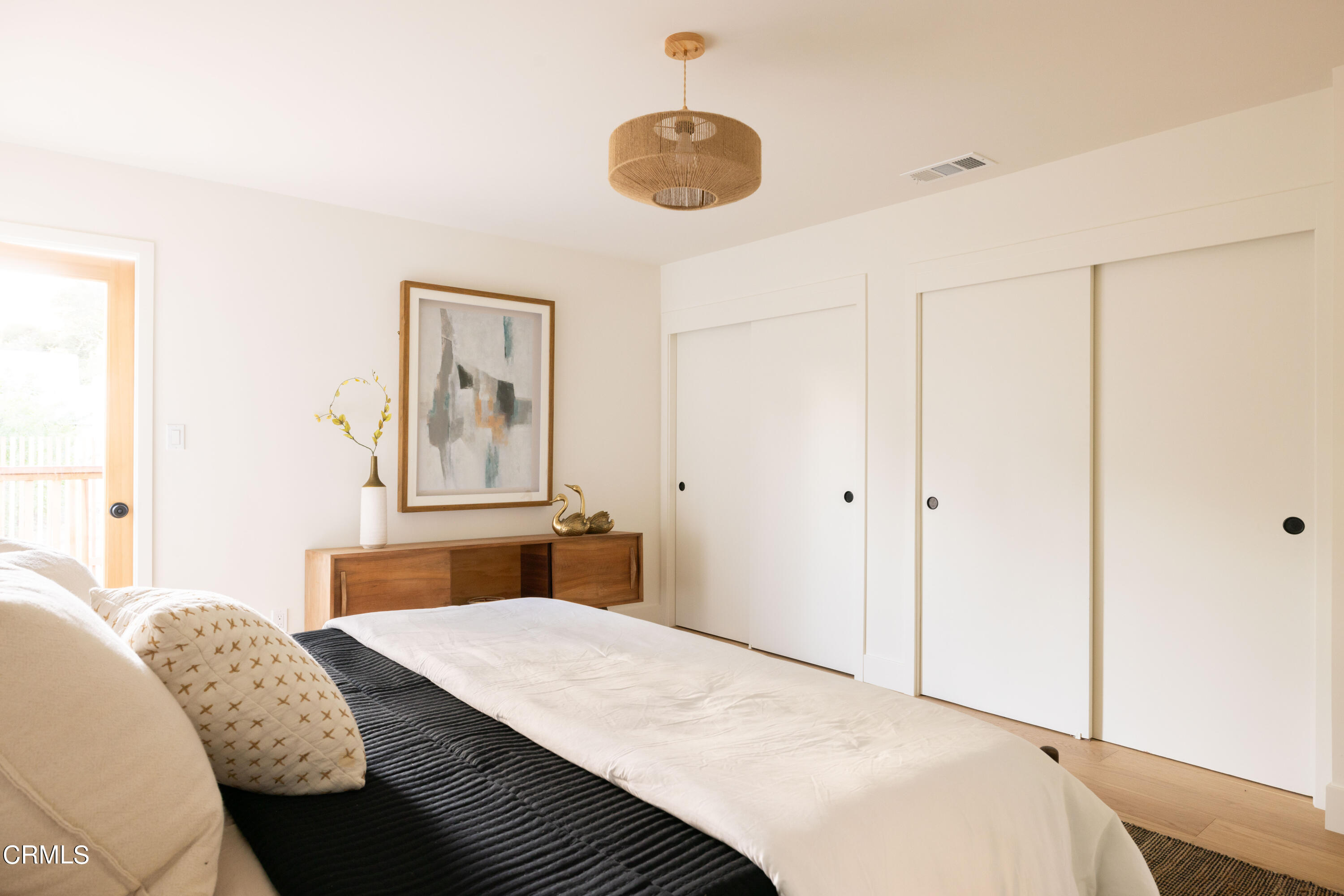 1054 Rutland Avenue Los Angeles, CA 90042 - Photo 13 of 27 a bedroom with a bed and a chandelier