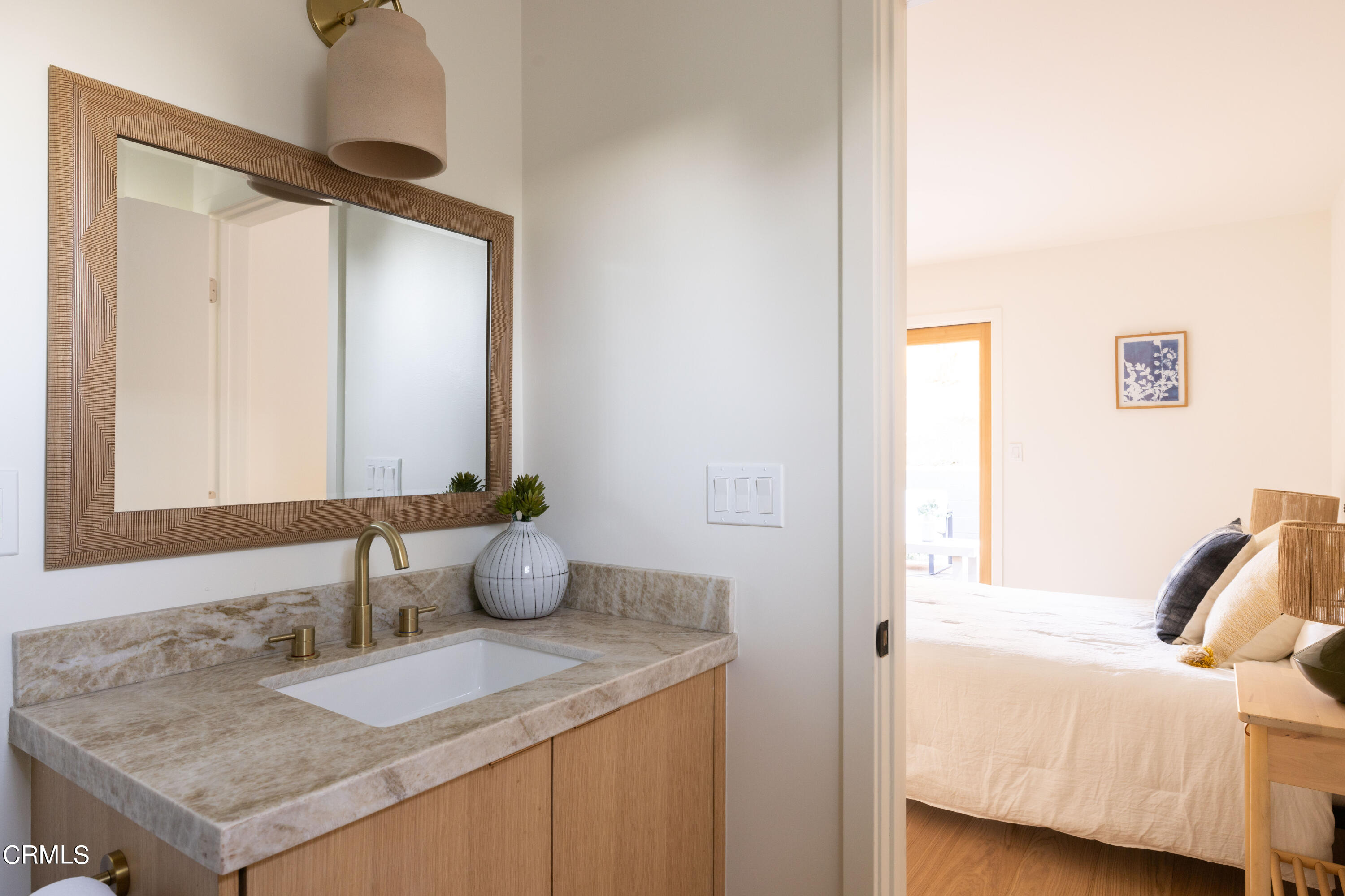 1054 Rutland Avenue Los Angeles, CA 90042 - Photo 18 of 27 a bathroom with a granite countertop sink and a mirror