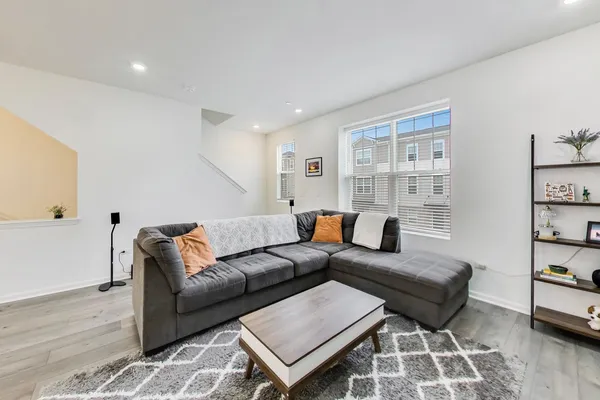 a living room with furniture and wooden floor