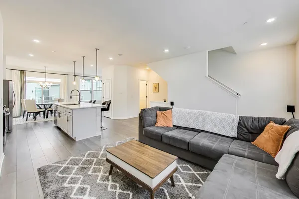 a living room with furniture and kitchen view