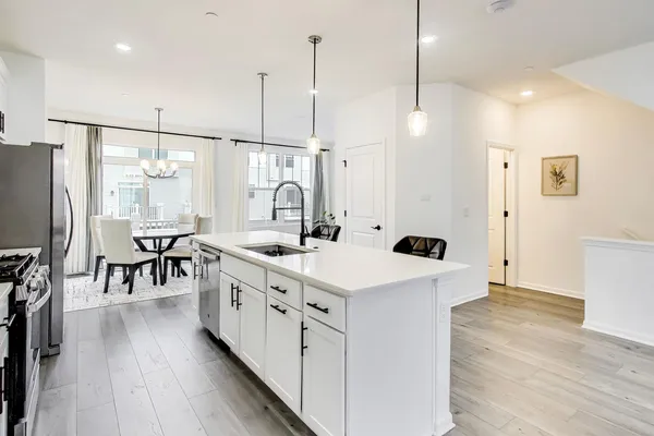 a kitchen with stainless steel appliances kitchen island a large counter and a sink