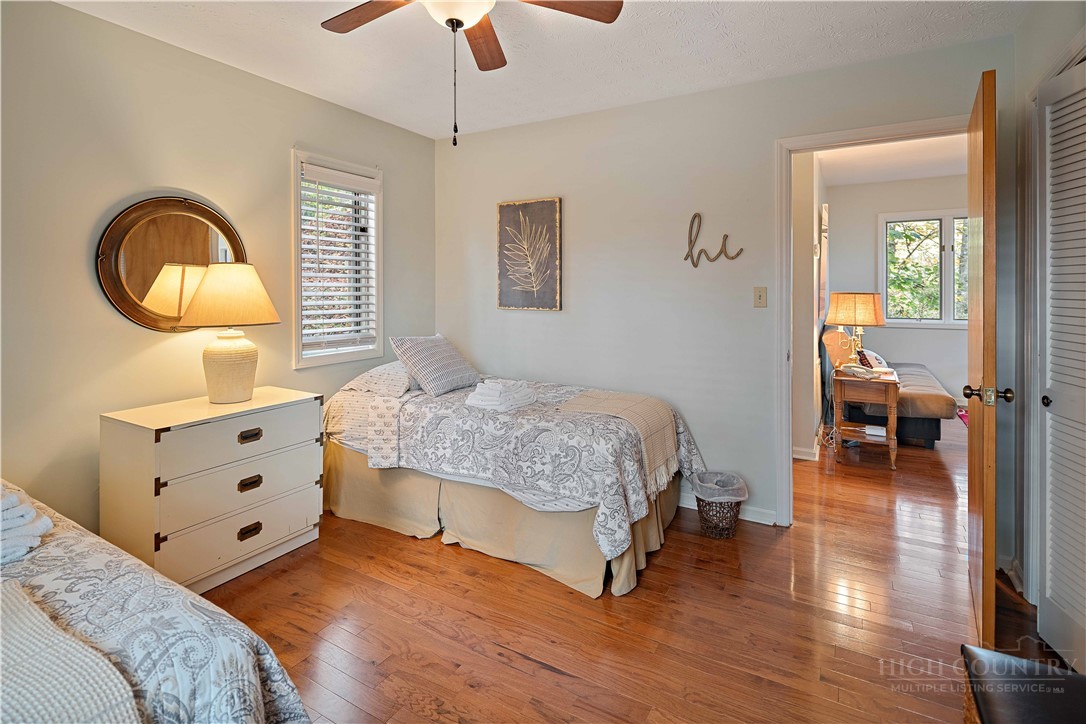 265 Leatherwood Road Banner Elk, NC 28604 - Photo 23 of 42 a bedroom with a bed and a chandelier
