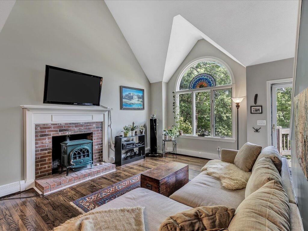 25 Moon Compass Lane Sandwich, MA 02563 - Photo 11 of 55 a living room with furniture a fireplace and a flat screen tv