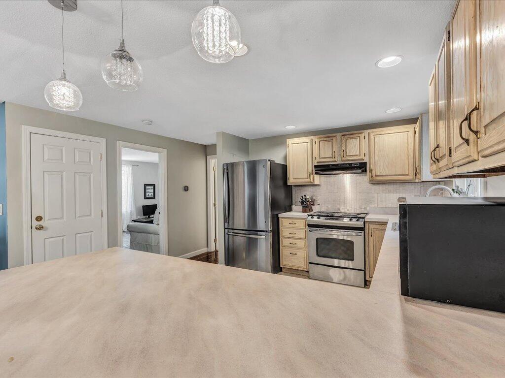 25 Moon Compass Lane Sandwich, MA 02563 - Photo 16 of 55 a large kitchen with stainless steel appliances granite countertop a stove and a refrigerator