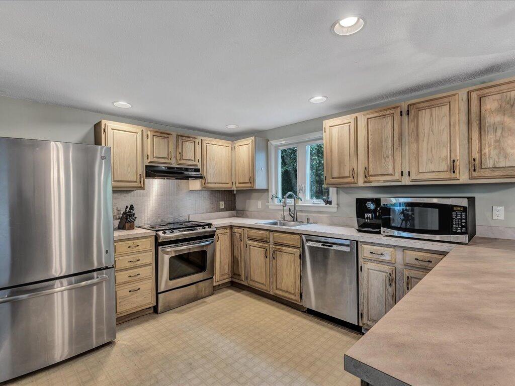 25 Moon Compass Lane Sandwich, MA 02563 - Photo 18 of 55 a kitchen with a refrigerator stove top oven and sink
