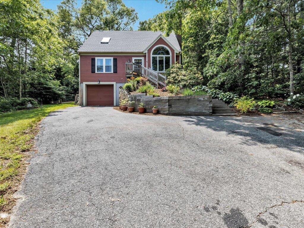25 Moon Compass Lane Sandwich, MA 02563 - Photo 3 of 55 a front view of a house with a yard and a garage