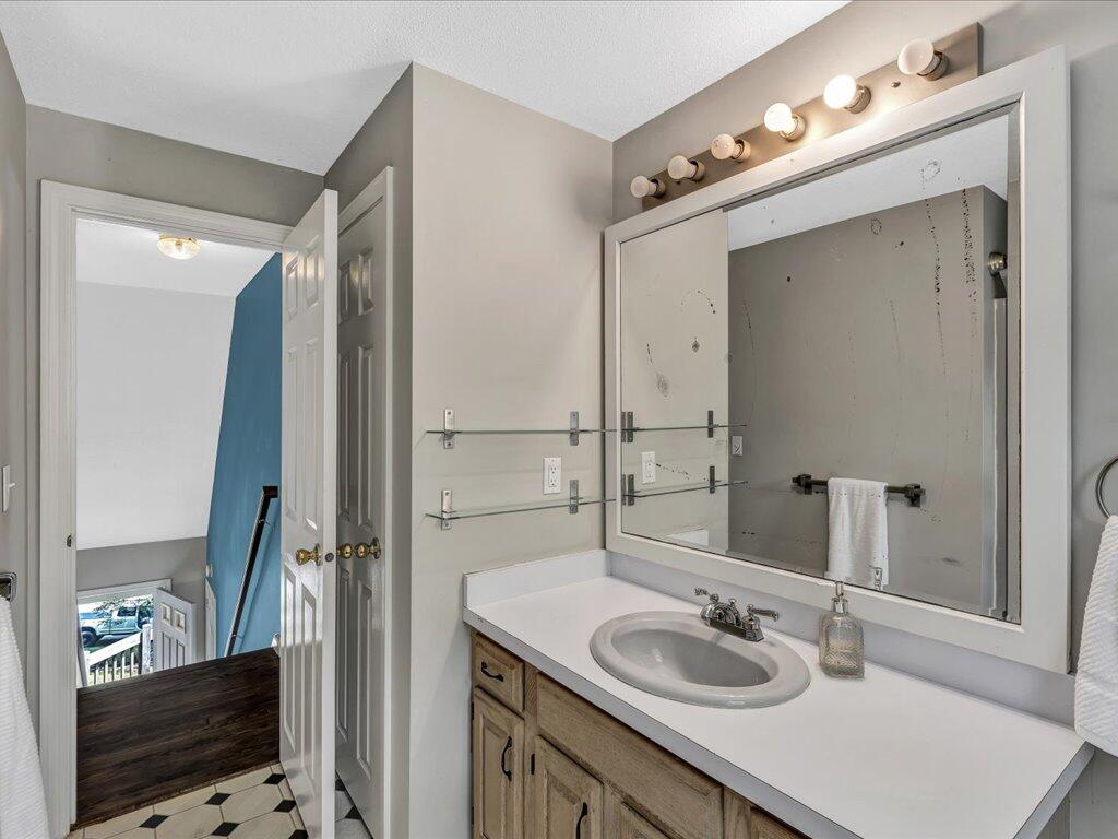 25 Moon Compass Lane Sandwich, MA 02563 - Photo 31 of 55 a bathroom with a sink vanity granite and a mirror