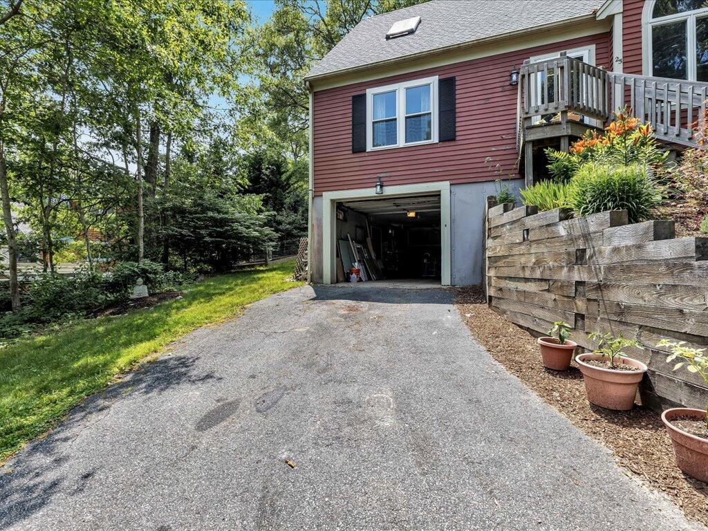 25 Moon Compass Lane Sandwich, MA 02563 - Photo 4 of 55 a view of a brick house with a yard and potted plants