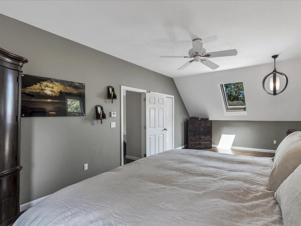 25 Moon Compass Lane Sandwich, MA 02563 - Photo 41 of 55 a bedroom with a bed and a chandelier