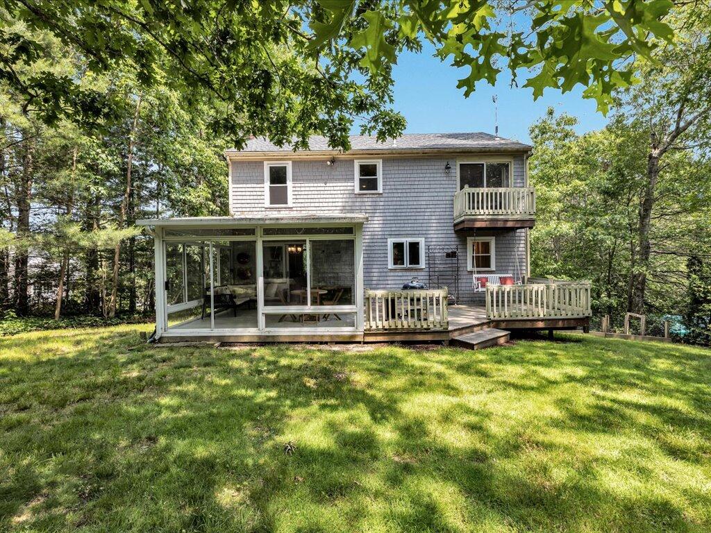 25 Moon Compass Lane Sandwich, MA 02563 - Photo 52 of 55 a front view of a house with a garden and yard