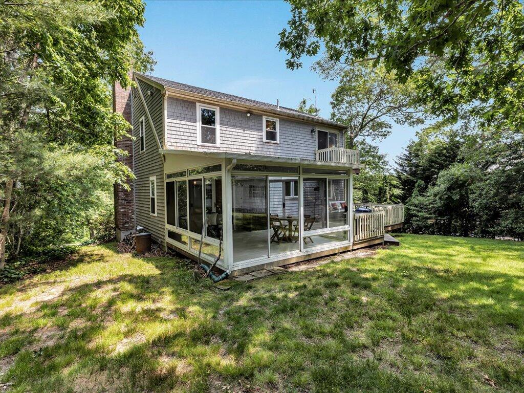 25 Moon Compass Lane Sandwich, MA 02563 - Photo 53 of 55 a view of a house with a yard and large tree
