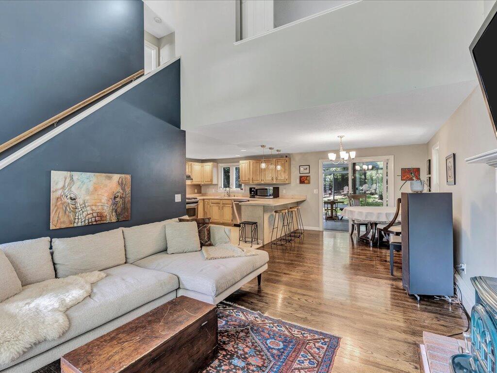25 Moon Compass Lane Sandwich, MA 02563 - Photo 9 of 55 a living room with furniture and a dining table with projector and a rug