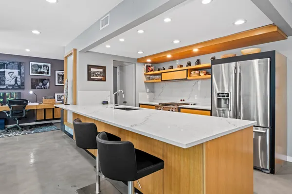 a kitchen with stainless steel appliances a sink and a refrigerator
