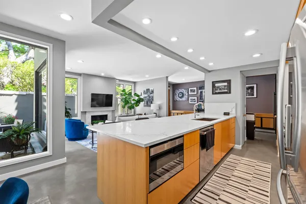 a large kitchen with kitchen island a large counter space and stainless steel appliances