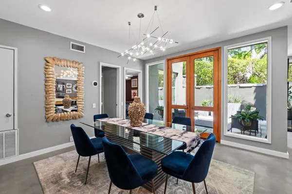 a view of a dining room with furniture large windows and wooden floor