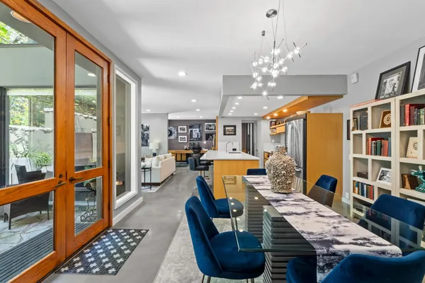 a living room with furniture a rug and a chandelier