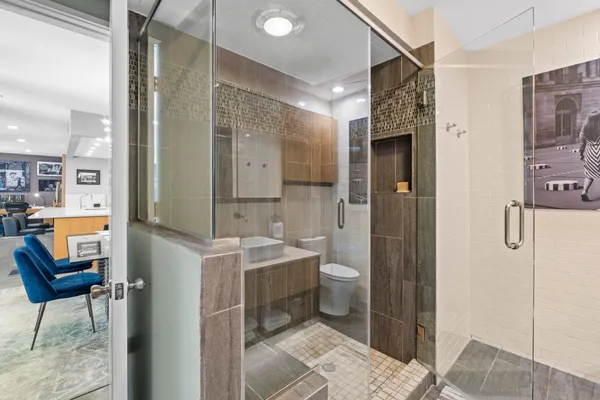 a bathroom with a sink a toilet and shower