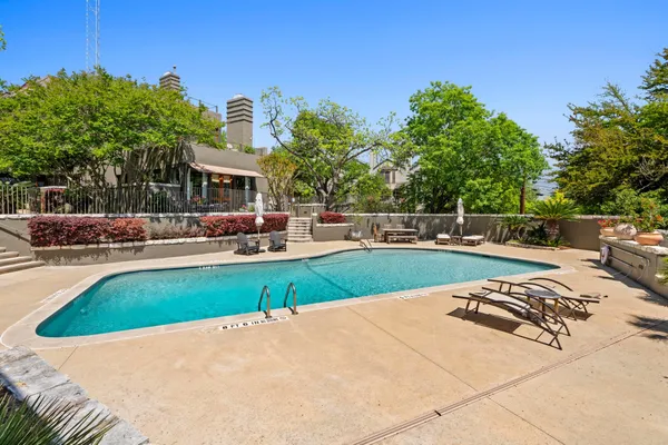 a view of a swimming pool with a lounge chair