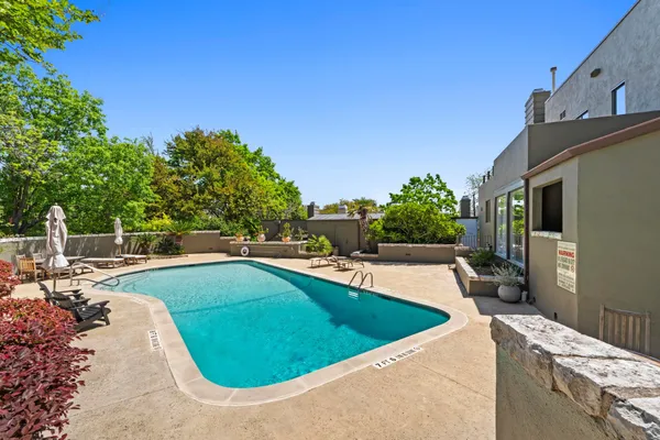 a view of a swimming pool with an outdoor seating