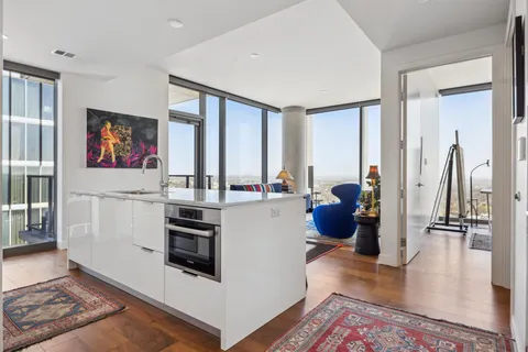 a kitchen with stainless steel appliances a stove a refrigerator and cabinets