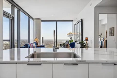 a kitchen with kitchen island a sink and a large window