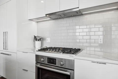 a stove top oven sitting inside of a kitchen