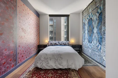 a bedroom with a bed and a chandelier