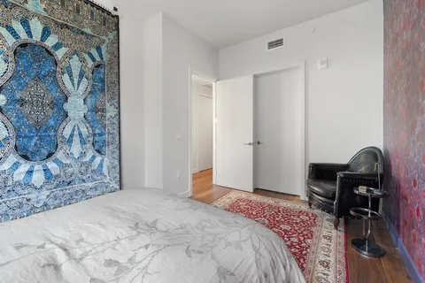 a bedroom with a bed and a desk
