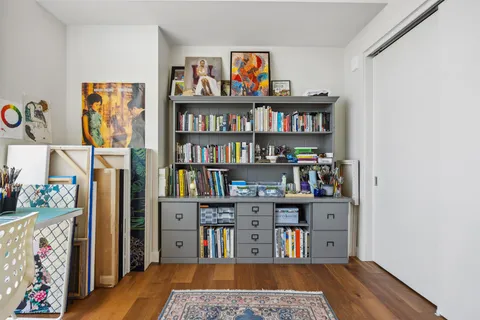 a view of a workspace with bookshelf