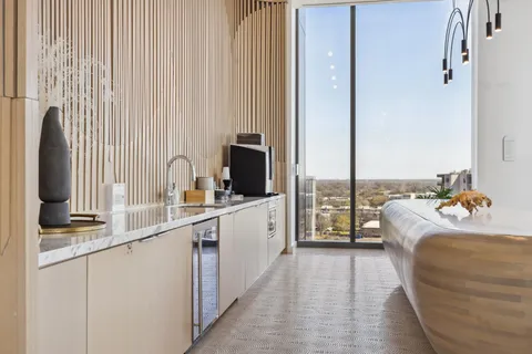 a large white kitchen with a large window