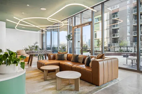 a living room with furniture and a floor to ceiling window