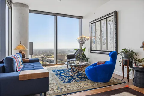 a living room with furniture a rug and a window