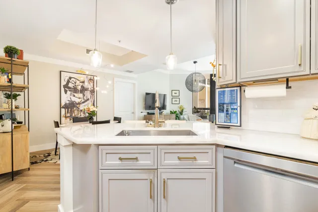 a kitchen with a sink a counter space and stainless steel appliances