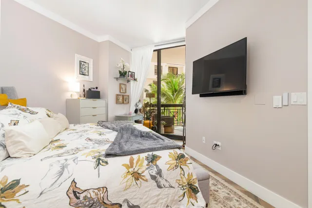 a bedroom with a bed and flat screen tv