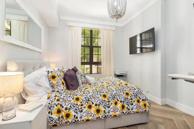 a bedroom with a bed and dresser