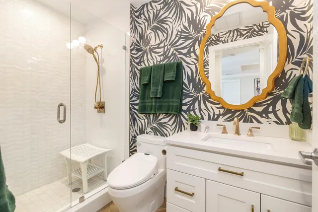a bathroom with a sink mirror vanity and toilet