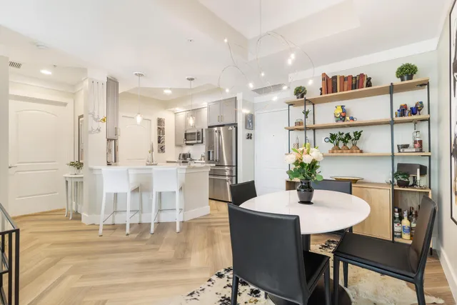 a kitchen with stainless steel appliances kitchen island granite countertop a table and chairs