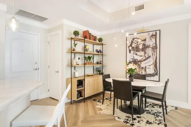 a workspace with wooden floor and a chandelier