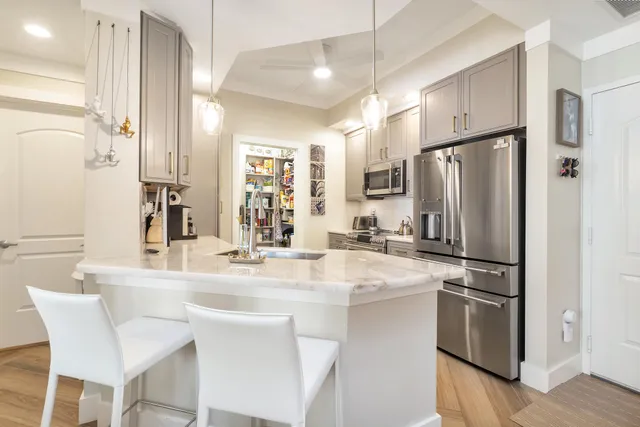a kitchen with stainless steel appliances a refrigerator sink and stove