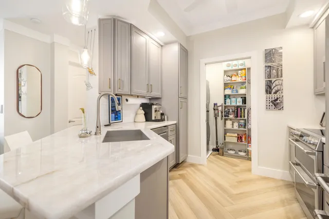 a kitchen with stainless steel appliances granite countertop a sink refrigerator and cabinets