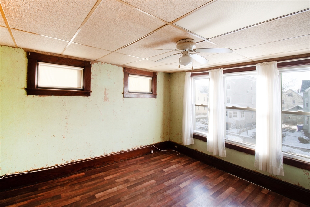 39-41 Malden Street Springfield, MA 01108 - Photo 16 of 27 a view of an empty room with a window and wooden floor
