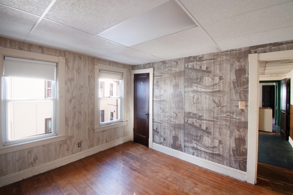 39-41 Malden Street Springfield, MA 01108 - Photo 19 of 27 a view of an empty room with wooden floor and a window